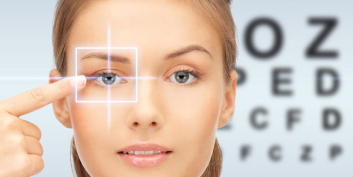 beautiful young woman pointing finger to her eye